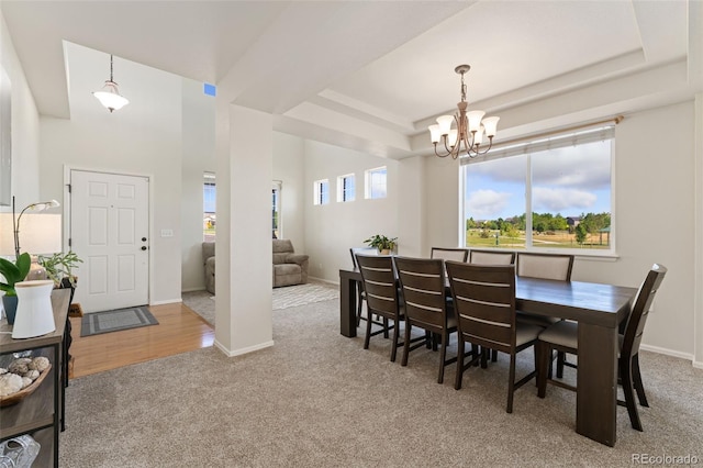 12978 Newport Way, Thornton, CO 80602 - dining room with carpet flooring, a chandelier, and a raised ceiling