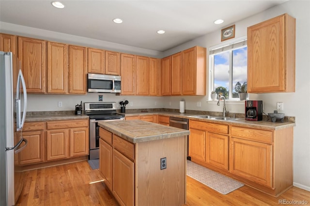 12978 Newport Way, Thornton, CO 80602 - kitchen with stainless steel appliances, a center island, light wood-style floors, recessed lighting, and light countertops