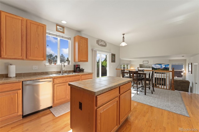 12978 Newport Way, Thornton, CO 80602 - kitchen with stainless steel dishwasher, tile countertops, light wood-type flooring, hanging light fixtures, and recessed lighting