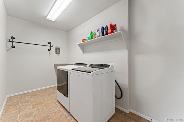 12978 Newport Way, Thornton, CO 80602 - laundry room with washing machine and clothes dryer and light stone finish flooring