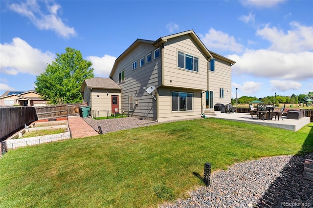 12978 Newport Way, Thornton, CO 80602 - rear view of house with a patio area, a fenced backyard, and a garden
