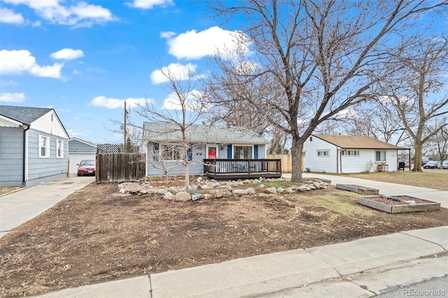 view of front of property featuring a wooden deck and fence