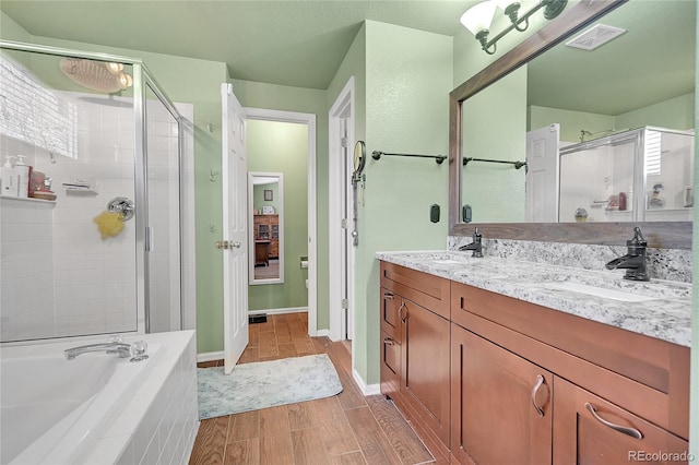 full bath with wood finished floors, visible vents, a sink, a shower stall, and a bath