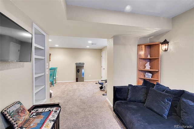 living room featuring carpet, baseboards, and recessed lighting