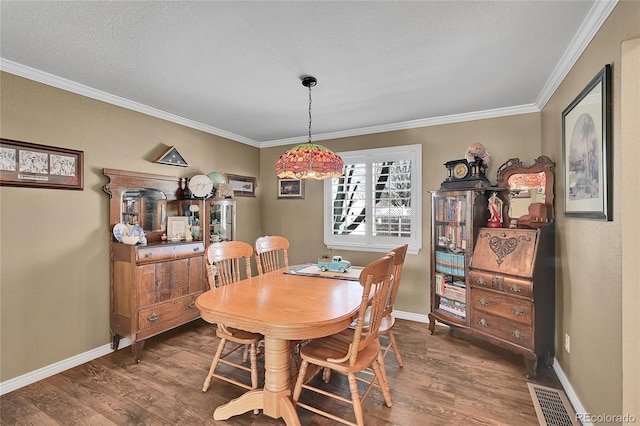 14558 Vine St, Thornton, CO 80602 - dining space with wood finished floors, crown molding, and a textured ceiling