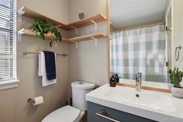 bathroom with vanity, toilet, and a shower with curtain