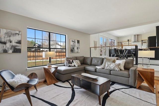 living room with baseboards and light wood finished floors