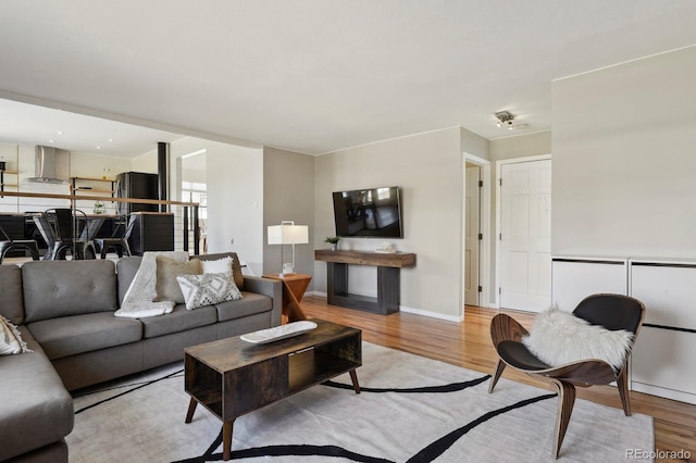 living room with baseboards and light wood-type flooring