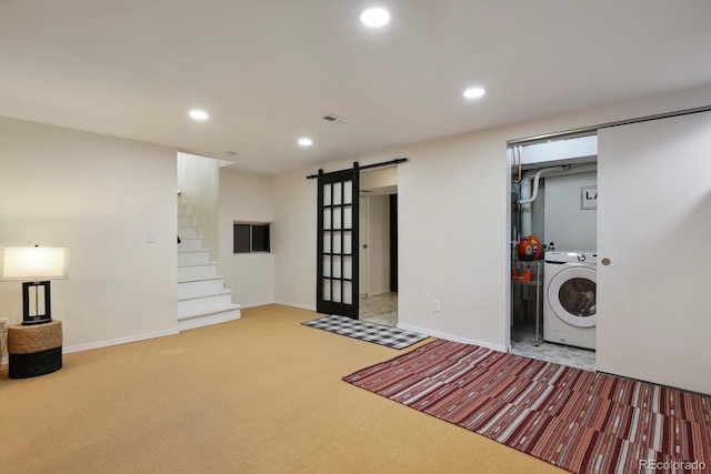interior space with laundry area, washer / clothes dryer, a barn door, carpet floors, and recessed lighting
