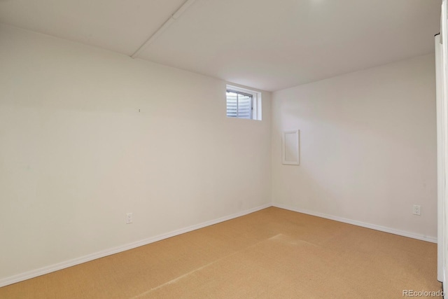 basement with baseboards and carpet flooring