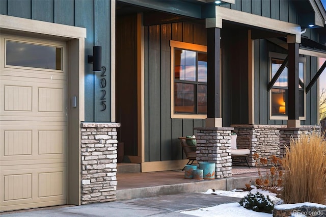 snow covered property entrance featuring covered porch