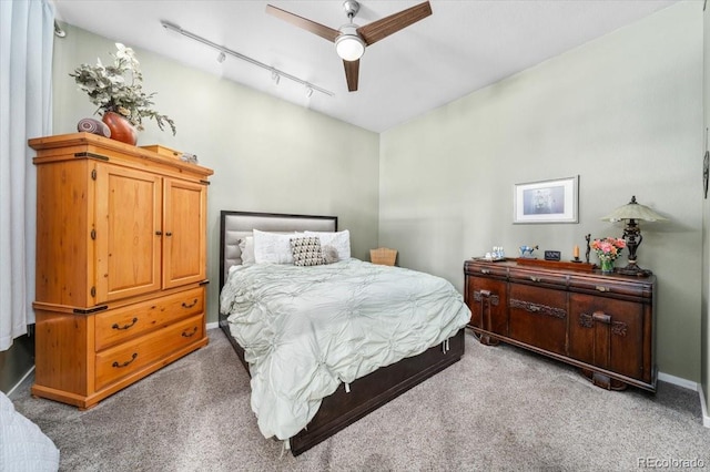 bedroom with rail lighting, light colored carpet, and ceiling fan