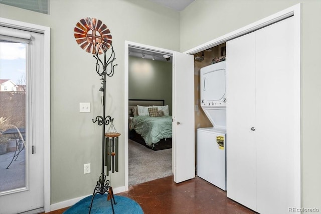 washroom with stacked washer and dryer