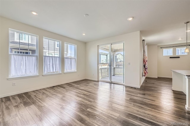 17530 E 95th Ave, Commerce City, CO 80022 - unfurnished living room with dark wood finished floors, baseboards, and recessed lighting