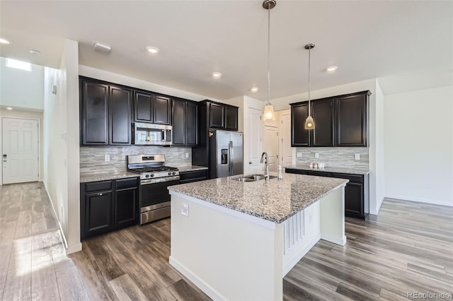 17530 E 95th Ave, Commerce City, CO 80022 - kitchen with appliances with stainless steel finishes, a sink, wood finished floors, and recessed lighting