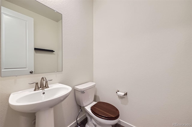 17530 E 95th Ave, Commerce City, CO 80022 - bathroom with baseboards, toilet, and a sink