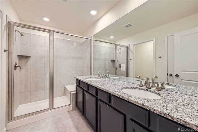 17530 E 95th Ave, Commerce City, CO 80022 - full bath with tile patterned flooring, a shower stall, double vanity, and recessed lighting
