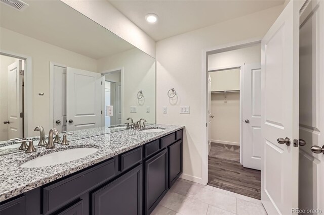 17530 E 95th Ave, Commerce City, CO 80022 - bathroom with double vanity, baseboards, and tile patterned floors