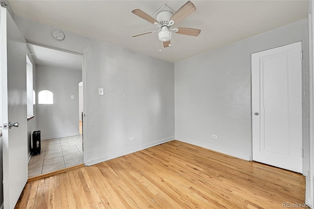 spare room featuring hardwood / wood-style floors and ceiling fan