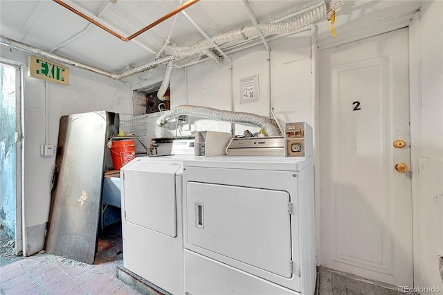 clothes washing area featuring independent washer and dryer