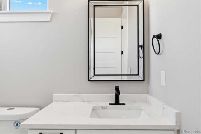 bathroom with vanity and toilet