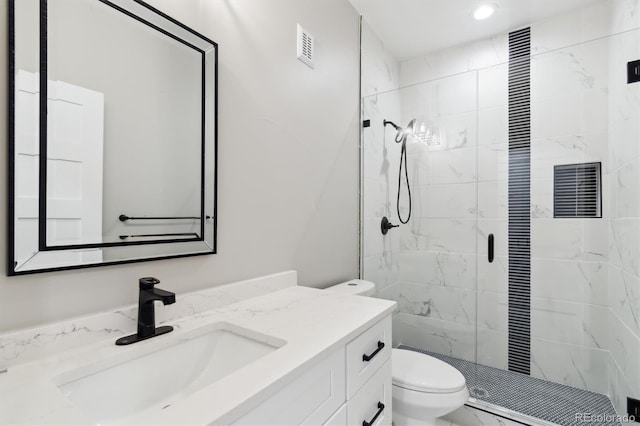 bathroom featuring walk in shower, vanity, and toilet