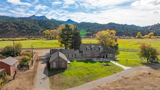 drone / aerial view with a mountain view and a rural view