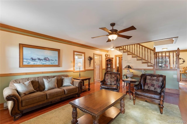 living room with hardwood / wood-style floors, ceiling fan, and ornamental molding