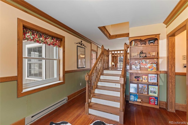 stairway with hardwood / wood-style flooring, baseboard heating, and crown molding