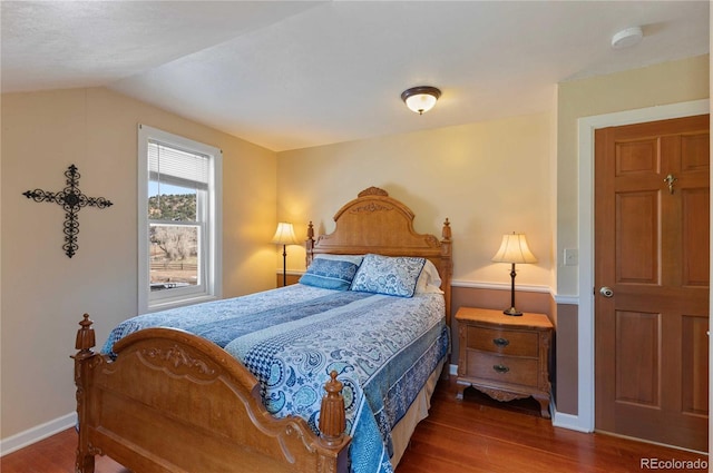 bedroom with hardwood / wood-style flooring and vaulted ceiling