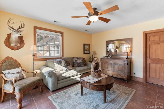 tiled living room with ceiling fan