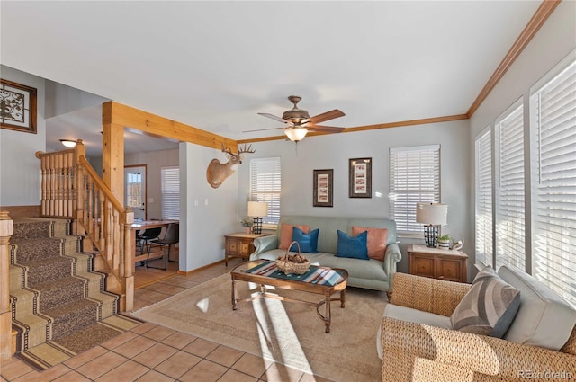 tiled living room with ceiling fan, ornamental molding, and a wealth of natural light