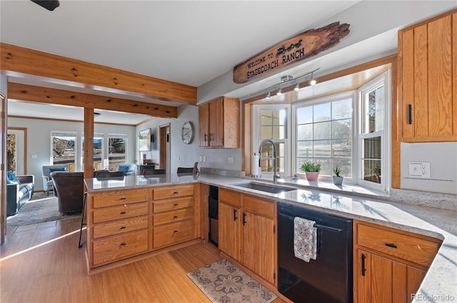 kitchen featuring kitchen peninsula, black dishwasher, light hardwood / wood-style floors, and sink