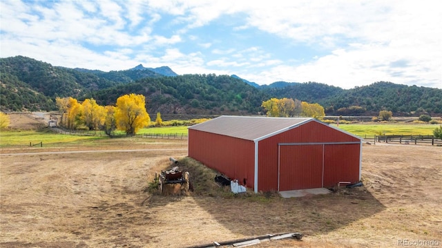 view of outbuilding with a mountain view and a rural view