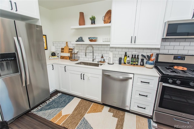 2876 W 53rd Ave Unit 106, Denver, CO 80221 - kitchen with appliances with stainless steel finishes, a sink, light countertops, and white cabinets