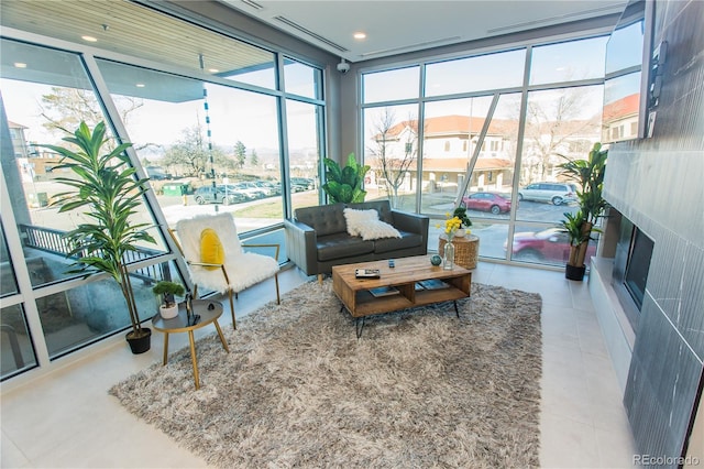 2876 W 53rd Ave Unit 106, Denver, CO 80221 - tiled living room featuring healthy amount of natural light, a fireplace, and floor to ceiling windows