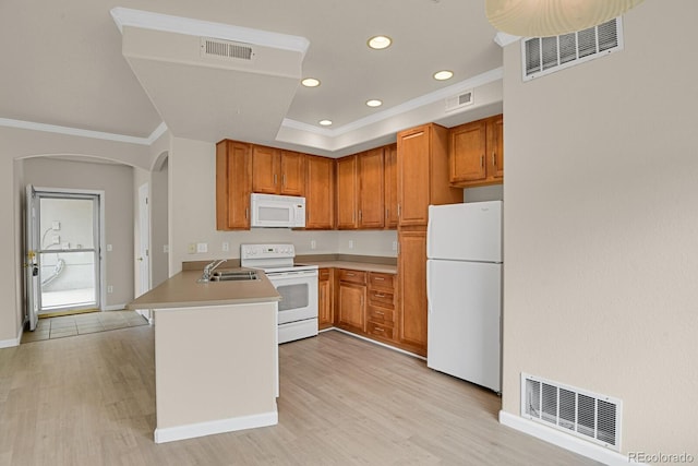 1801 S Dunkirk St Unit 108, Aurora, CO 80017 - kitchen with white appliances, arched walkways, a peninsula, crown molding, and light wood-type flooring