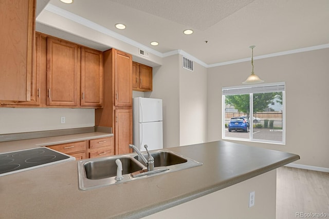 1801 S Dunkirk St Unit 108, Aurora, CO 80017 - kitchen with freestanding refrigerator, recessed lighting, ornamental molding, pendant lighting, and light wood-type flooring