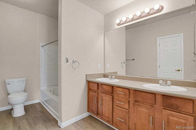 1801 S Dunkirk St Unit 108, Aurora, CO 80017 - bathroom with double vanity, wood finished floors, and bathtub / shower combination