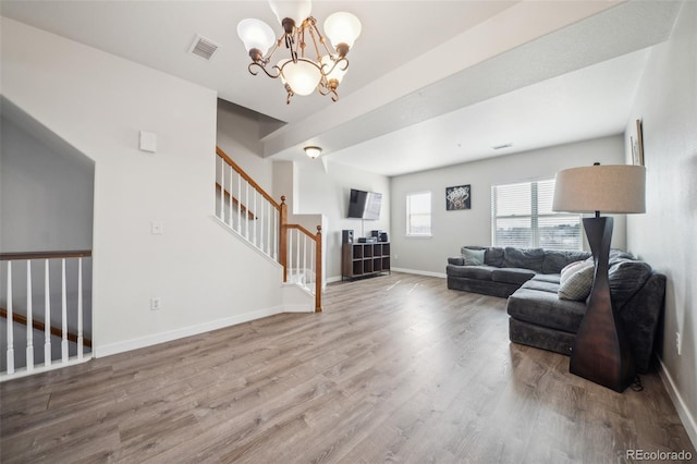 18726 E Yale Cir Unit D, Aurora, CO 80013 - living area featuring wood finished floors, baseboards, a chandelier, and stairway