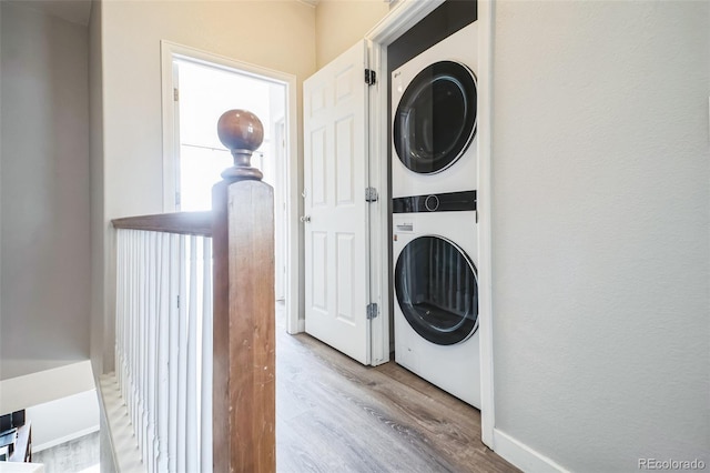 18726 E Yale Cir Unit D, Aurora, CO 80013 - laundry room featuring stacked washer / dryer and wood finished floors