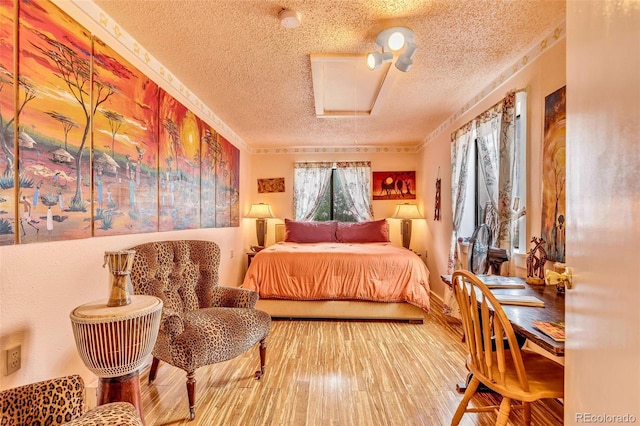237 Foxtail Ct, Fairplay, CO 80440 - bedroom with a textured ceiling, wood finished floors, and attic access