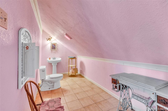 237 Foxtail Ct, Fairplay, CO 80440 - half bathroom featuring a textured wall, vaulted ceiling, tile patterned flooring, and a textured ceiling