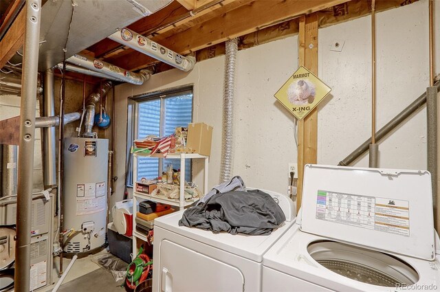 clothes washing area with gas water heater and washing machine and dryer