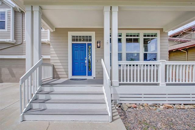 8545 Braun Loop, Arvada, CO 80005 - view of exterior entry with a porch, an attached garage, and concrete driveway