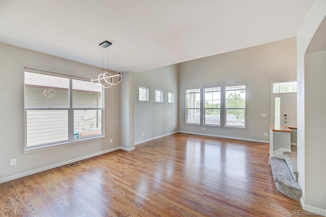 8545 Braun Loop, Arvada, CO 80005 - empty room with a chandelier, wood finished floors, and baseboards