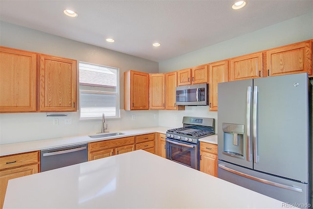 8545 Braun Loop, Arvada, CO 80005 - kitchen featuring stainless steel appliances, a sink, light countertops, recessed lighting, and light brown cabinetry