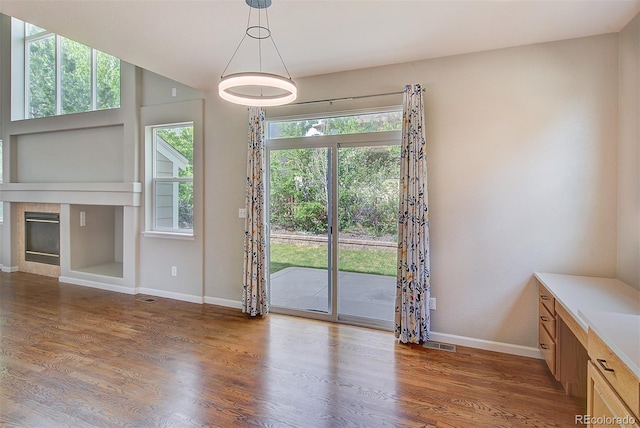 8545 Braun Loop, Arvada, CO 80005 - unfurnished dining area with baseboards, wood finished floors, and a fireplace