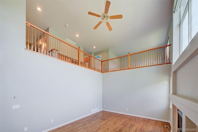 8545 Braun Loop, Arvada, CO 80005 - unfurnished room featuring a ceiling fan, a high ceiling, wood finished floors, recessed lighting, and baseboards
