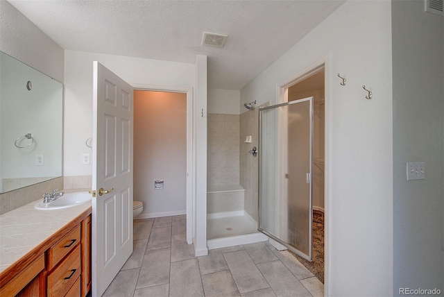 8545 Braun Loop, Arvada, CO 80005 - bathroom with a shower stall, toilet, tile patterned flooring, vanity, and baseboards